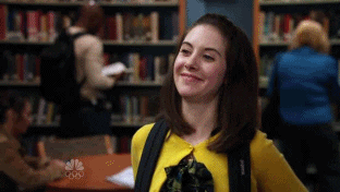GIF of a woman waving in a super-awkward way. Everything I do is super-awkward.